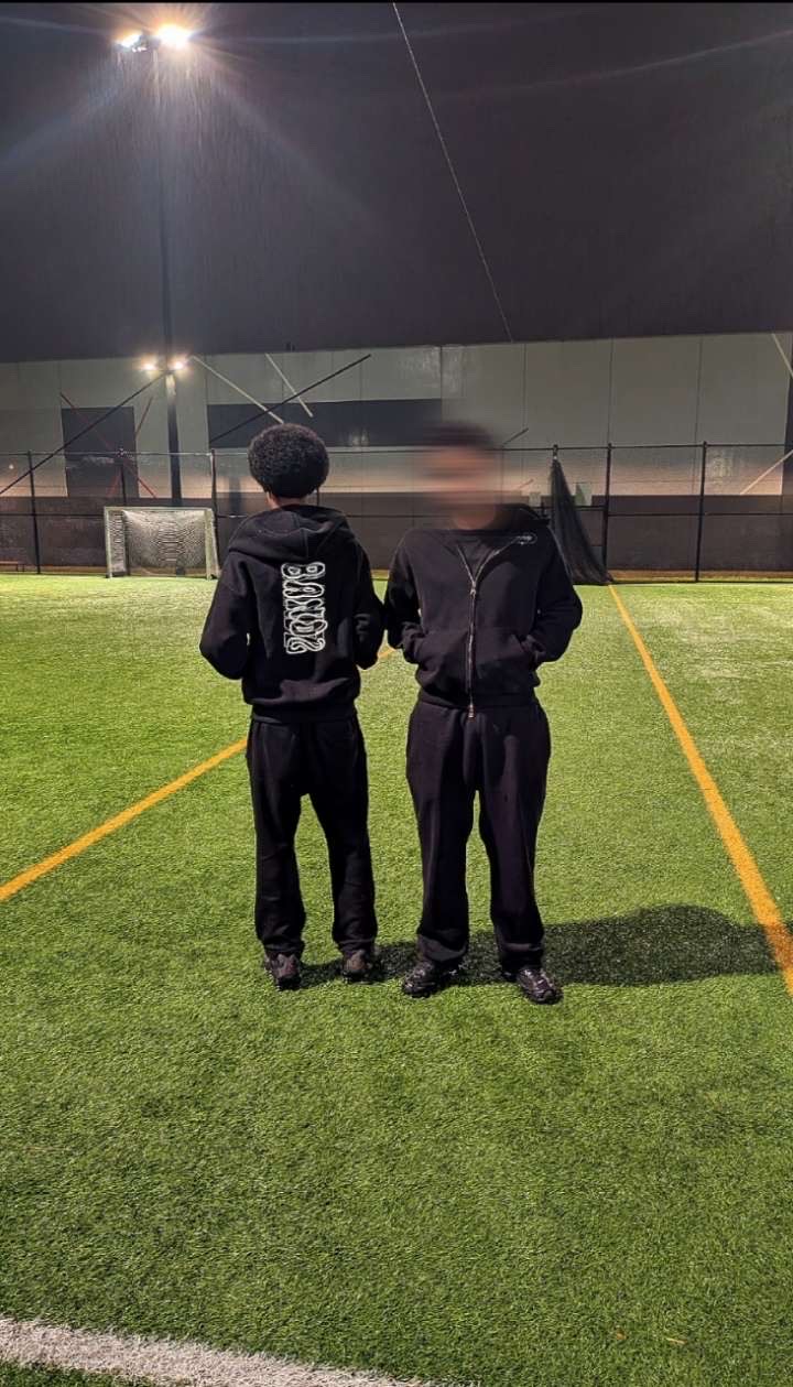 Two models wearing the Bandz zip hoodie